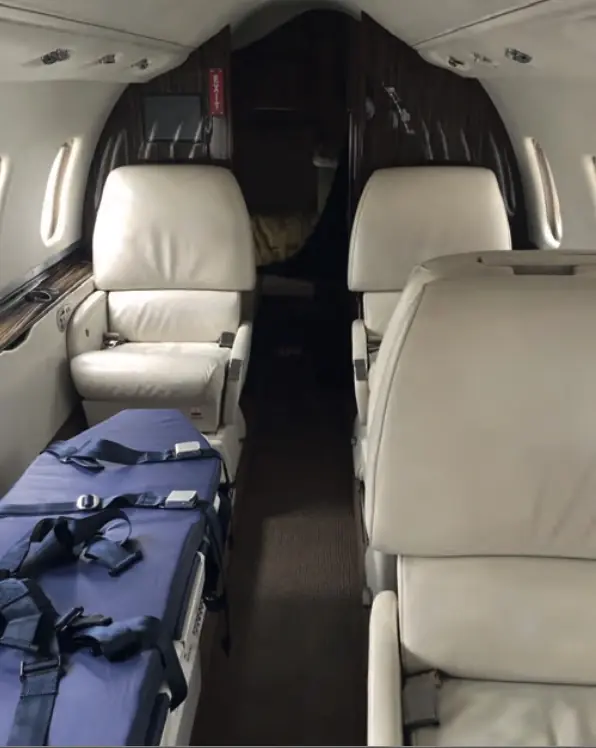 Inside a Red Dot Air Ambulance Learjet 60 cabin showing the aeromedical stretcher and forward seating